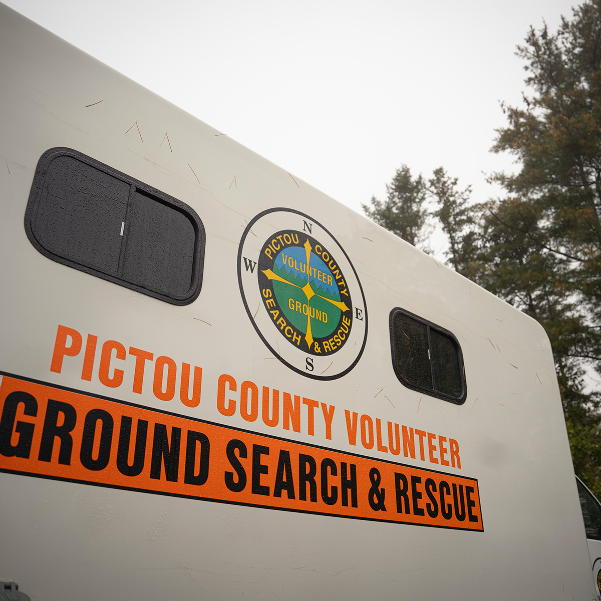 The side of the mobile command post displaying our page with orange lettering underneath reading 'Pictou County Volunteer Ground Search & Rescue'