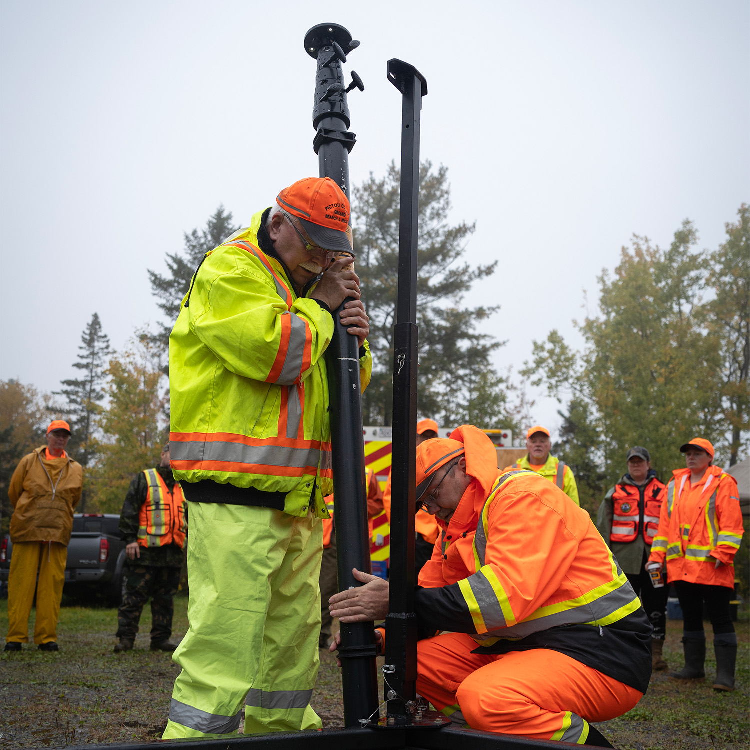 Two people assemble a radio tower as a training exersize.